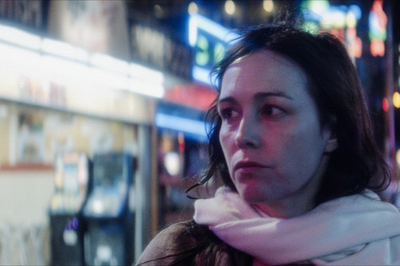 Filmstill Les paradis de Diane. Gesicht von einer Frau auf einer beleuchteten Strasse.